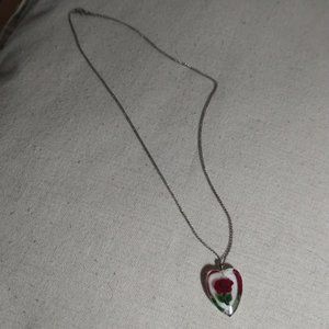 Flower heart pendent on sterling marked chain necklace.